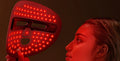 LUMÉA Pro LED face mask glowing red in hand