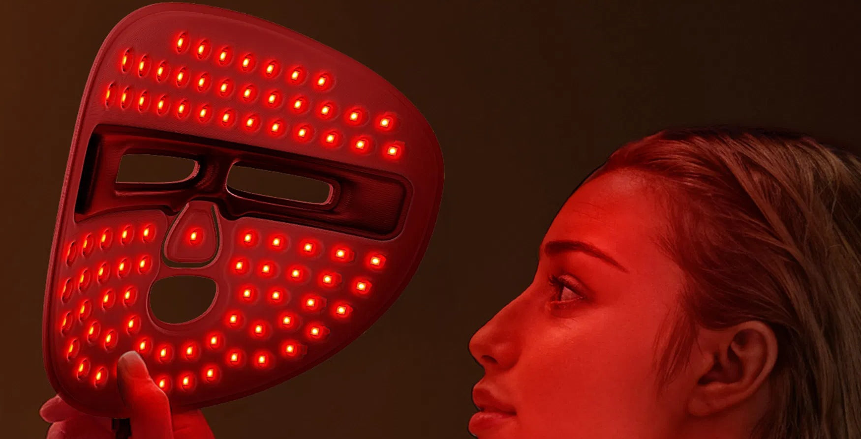LUMÉA Pro LED face mask glowing red in hand